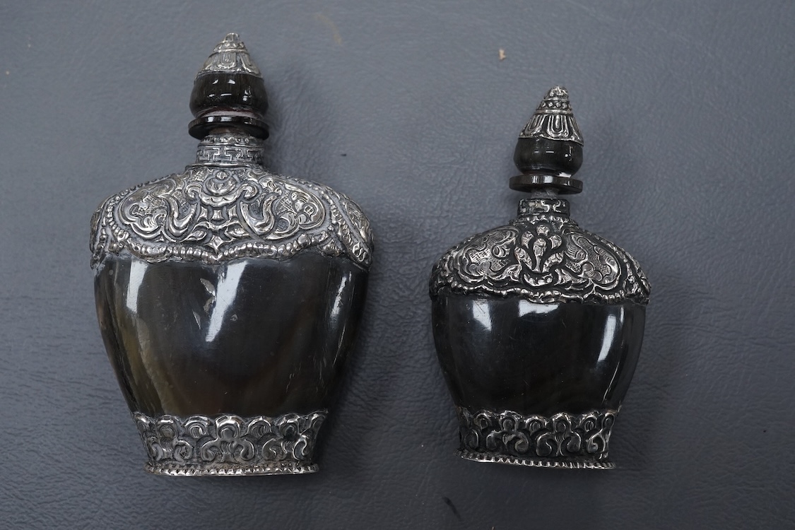 Two late 19th/early 20th century Nepalese embossed white metal mounted horn snuff bottles, largest 87mm.
